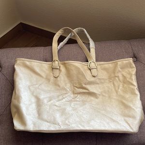 I’m selling a vintage gold tote bag from a designer brand.